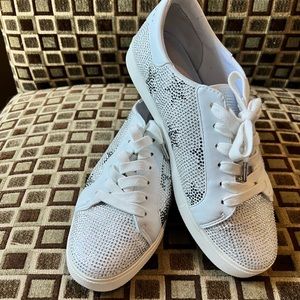 A crystal studded pair of low top sneakers bring chic style to your wardrobe.